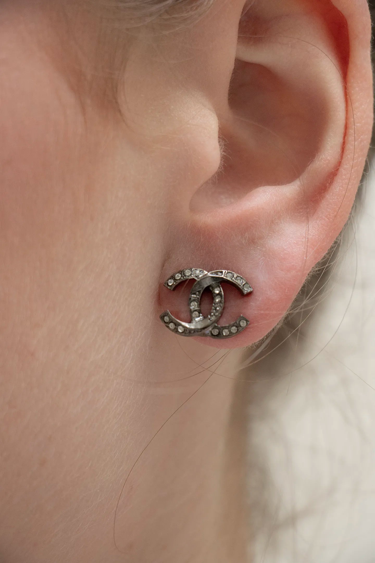 Boucle d'oreille portée CC vintage Chanel coloris noir gunmetal, poinçon Chanel gravé au dos, pièce d'archive.