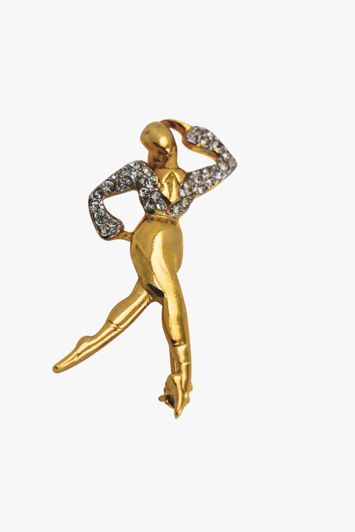 Broche en forme de danseur dorée avec détail de strass argenté sur le haut vintage 